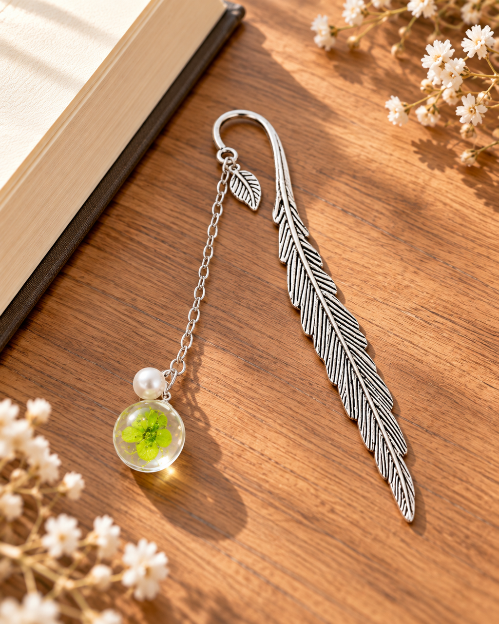Silver-tone metal feather bookmark with a colorful floral charm for books and journals. Product photo 5 of 6.