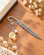 Silver-tone metal feather bookmark with a colorful floral charm for books and journals. Product photo 3 of 6.
