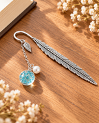 Silver-tone metal feather bookmark with a colorful floral charm for books and journals. Product photo 4 of 6.