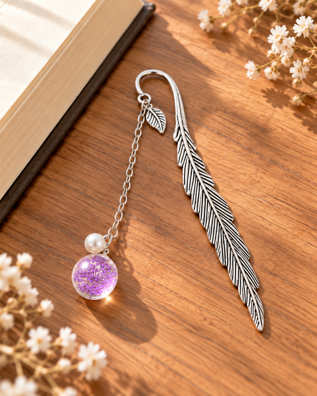 Silver-tone metal feather bookmark with a colorful floral charm for books and journals. Product photo 6 of 6.