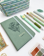 Faith green Christian stationery collection with a Scripture journal, writing tools, bookmarks, washi tape, and Bible study accessories. Product photo 2 of 4.