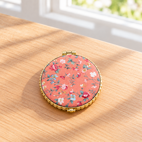 Boutique floral compact mirror with a padded exterior, gold-tone trim, and double mirrors. Product photo 2 of 4.