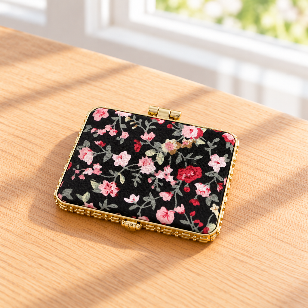 Boutique floral compact mirror with a padded exterior, gold-tone trim, and double mirrors. Product photo 3 of 4.