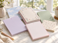 Decorative floral notepads in soft coordinating colors for lists, reminders, journaling, and gifts. Product photo 1 of 1.
