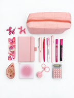 Strawberry Shortcake pink kids stationery collection flat lay with pencil case, A6 journal, writing tools, calculator, sticky notes, tape roller, fidget keychain, bookmark, and stickers.